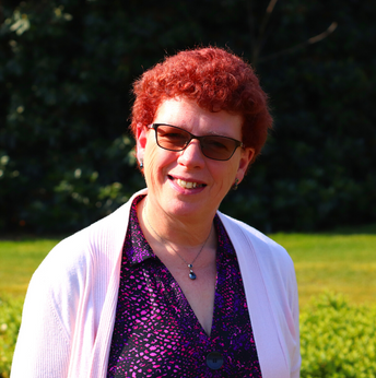 Elaine Heyworth in plum dress and white cardigan