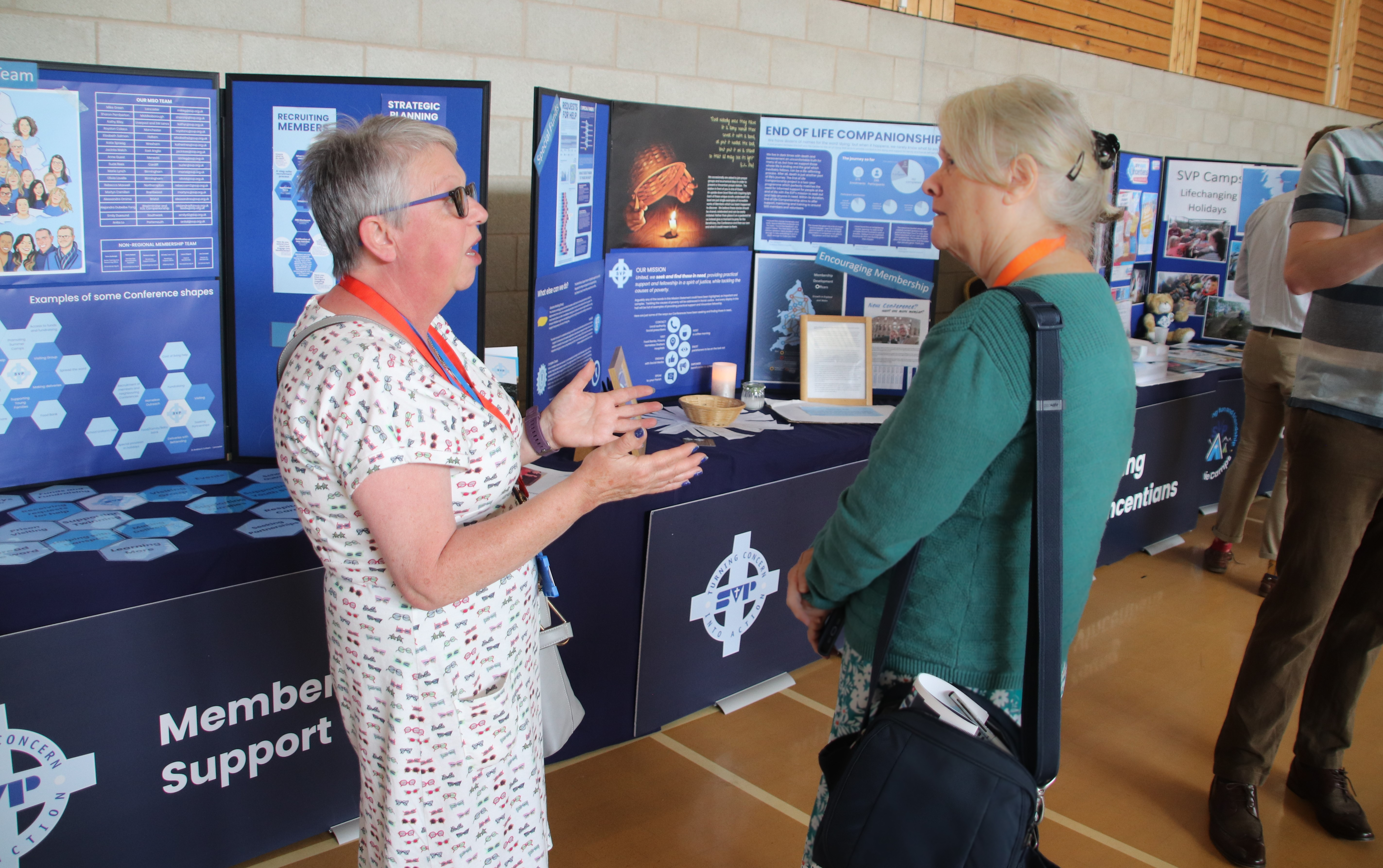 member and staff at conference stand