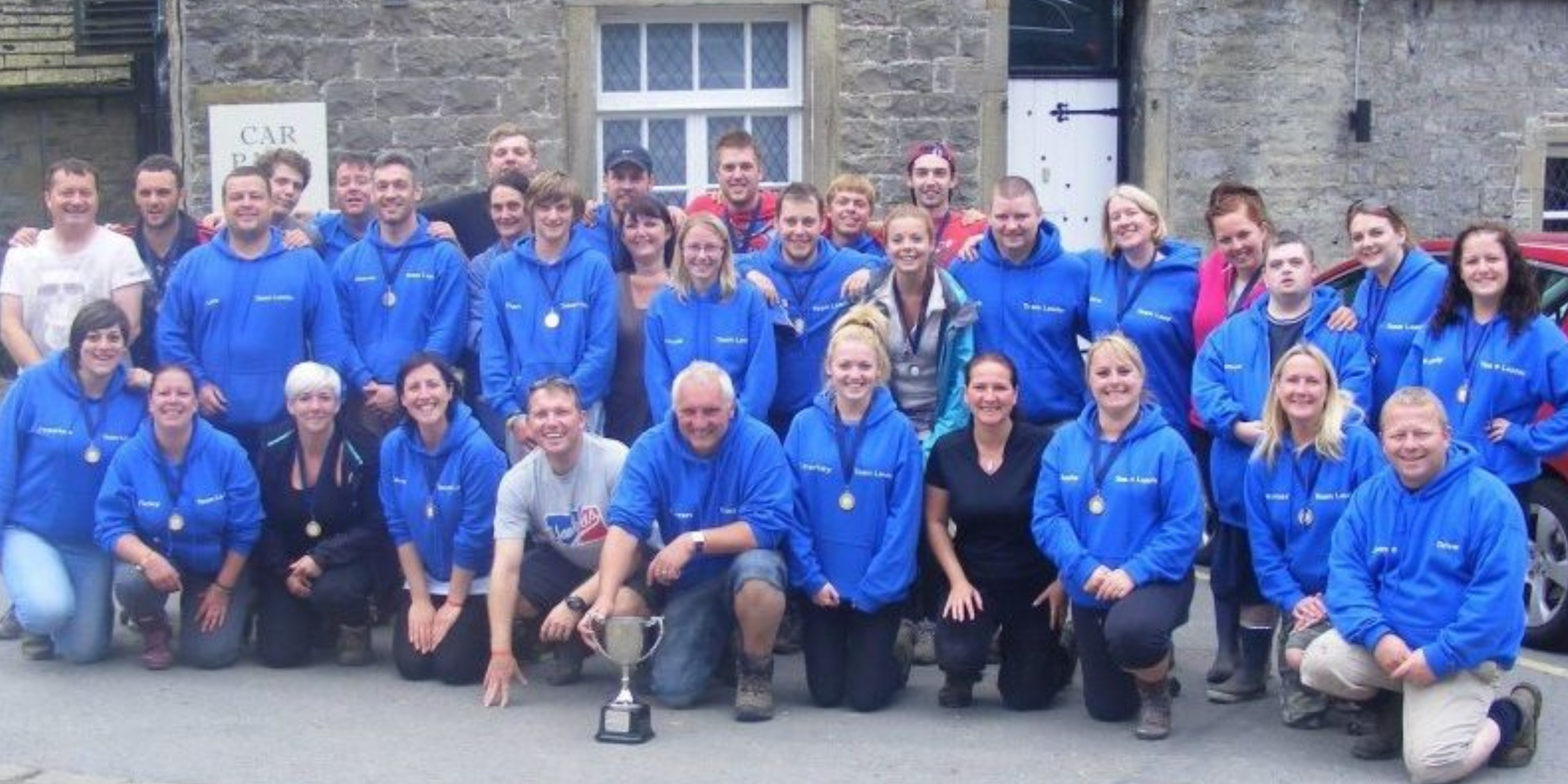 volunteers in blue sweatshirts